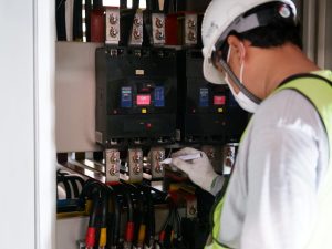 Homeowner reviewing electrical compliance certificate with electrician