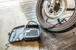Air compressor being used to inflate a vehicle tyre