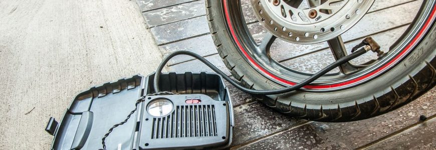 Air compressor being used to inflate a vehicle tyre