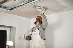Ceiling installer working on a residential ceiling